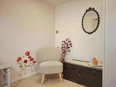 a room with a chair and a mirror on the wall at Melli's R-Home in Rome
