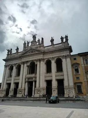a large building with a car parked in front of it at Piccola Domus in Rome