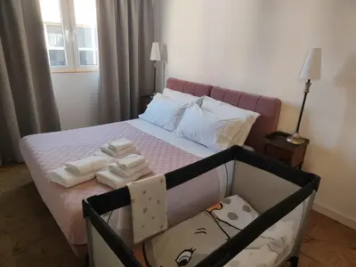 a bedroom with a bed with towels on it at Piccola Domus in Rome