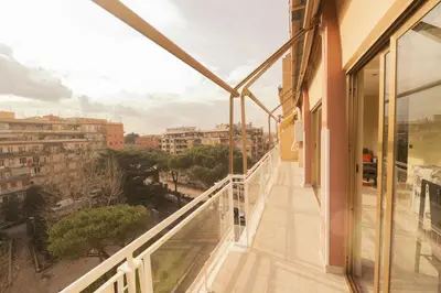 a balcony with a view of a city at Spacious and Bright 3BR Family Apartment in Rome