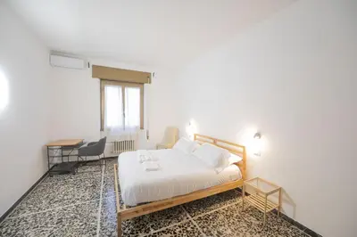a bedroom with a bed and a table and chairs at Spacious and Bright 3BR Family Apartment in Rome
