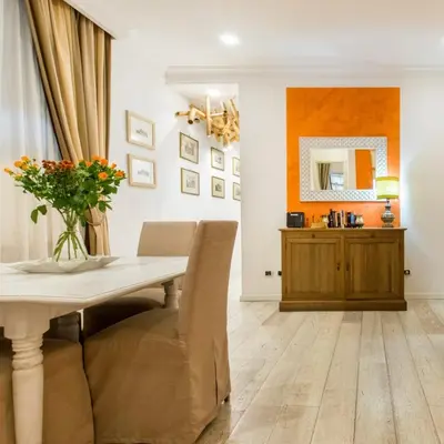 a dining room with a table and a mirror at Il patio al Colosseo in Rome