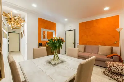 a living room with a table and a couch at Il patio al Colosseo in Rome