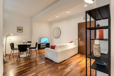 a living room with a white couch and a table at Etiopia Apartment in Rome