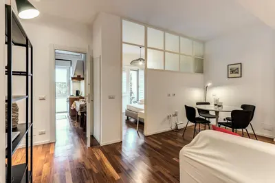 a living room and dining room with a table and chairs at Etiopia Apartment in Rome