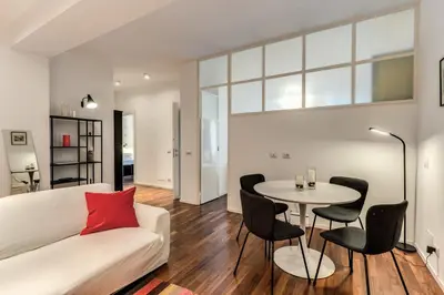 a living room with a white couch and a table at Etiopia Apartment in Rome