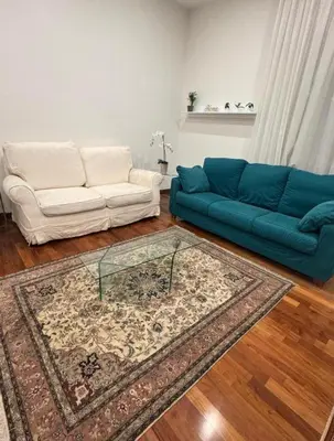 a living room with a couch and a glass table at 4M Apartment in Rome