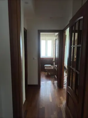 a room with a hallway with a door and a window at 4M Apartment in Rome