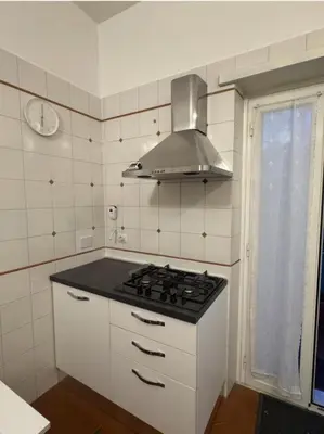 a kitchen with a stove top oven in a kitchen at 4M Apartment in Rome