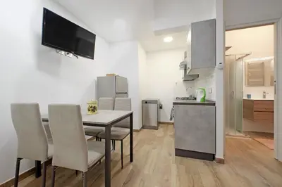 a kitchen and dining room with a table and chairs at Monica's house in Rome