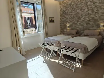 two beds in a room with a brick wall at La Casa di MiDa in Rome