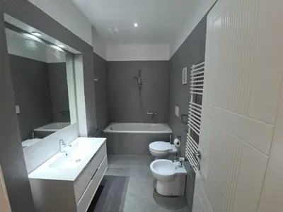 a bathroom with a sink and a toilet and a tub at Benny's House Rome in Rome