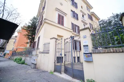 a building with a gate on the side of a street at Terrazza Monteverde by BuddyRent in Rome
