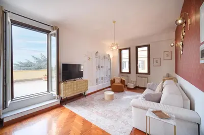 a living room with a couch and a large window at Terrazza Monteverde by BuddyRent in Rome