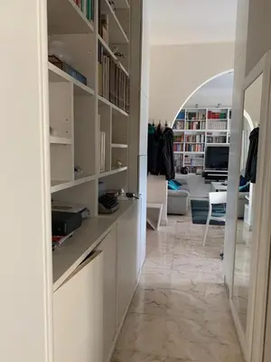 a living room with a hallway with white shelves at Miss Giulia Prime location flat in Rome in Rome