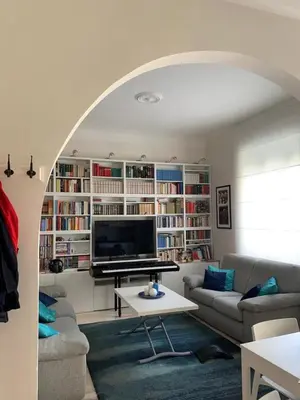 a living room with a couch and a table and a television at Miss Giulia Prime location flat in Rome in Rome