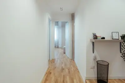 a hallway with white walls and a wooden floor at Marino's Apartment in Rome