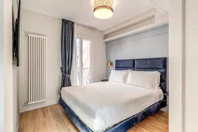 a bedroom with a large bed and a window at Maison Della Vite in Rome