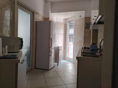 a kitchen with a refrigerator and a sink at Regina di Cuori in Rome