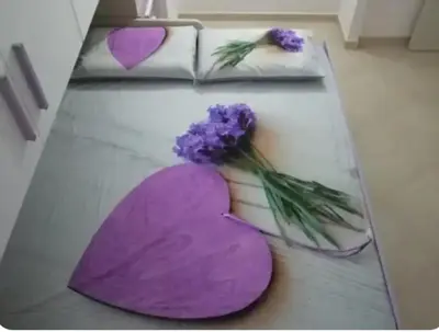 a table with two hearts and purple flowers on it at Regina di Cuori in Rome