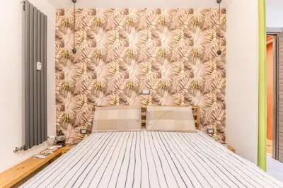 a bed in a room with a wall at Loves Home in Rome
