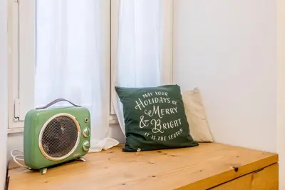 a pillow and a radio sitting on a wooden bench at Loves Home in Rome