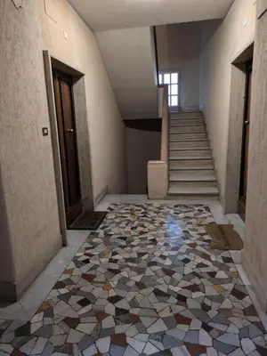 an empty hallway with a tile floor and stairs at Interno7 in Rome