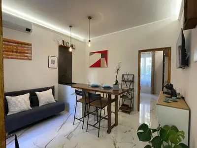 a living room with a table and a couch at Il giardinetto di Ponte Milvio in Rome