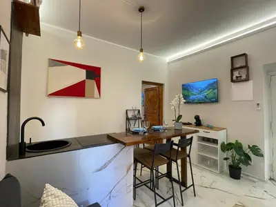 a kitchen with a table and chairs in a room at Il giardinetto di Ponte Milvio in Rome