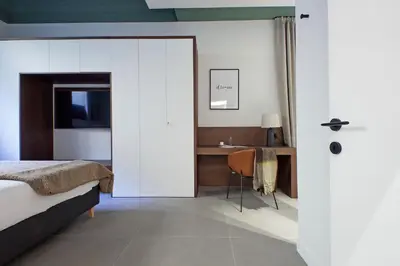 a bedroom with a bed and a desk with a chair at Crispi Loft - My Extra Home in Rome