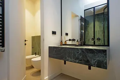a bathroom with a marble sink and a toilet at Crispi Loft - My Extra Home in Rome