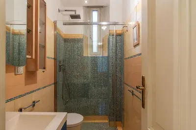 a bathroom with a shower with a toilet and a sink at GuestHost - Pretty Apartment near Musei Vaticani in Rome