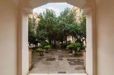 an open hallway with trees and potted plants at GuestHost - Pretty Apartment near Musei Vaticani in Rome
