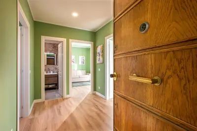 a room with green walls and a wooden door at Penthouse Lux with Panoramic View in Rome