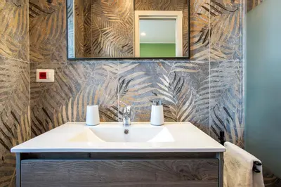 a bathroom with a sink and a mirror at Penthouse Lux with Panoramic View in Rome