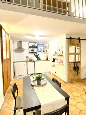a kitchen and dining room with a table and chairs at Dimora Ardeatina in Rome