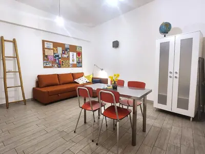 a living room with a table and chairs and a couch at Sanpietrino Home in Rome
