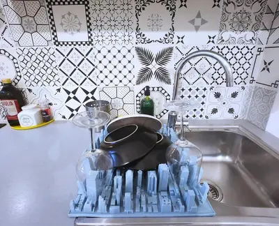 a kitchen sink with a pan and wine glasses at Sanpietrino Home in Rome