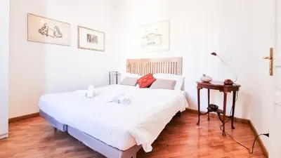 a bedroom with a white bed and a wooden floor at Luxury Penthouse with Terrace by Spanish Steps in Rome