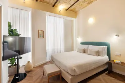 a bedroom with a bed and a large window at Elegantia Luxury Rooms Trastevere in Rome
