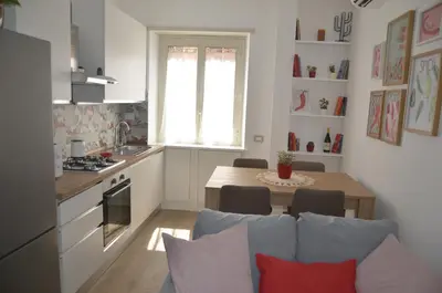 a kitchen and living room with a table and a dining room at 50 al Vaticano House in Rome