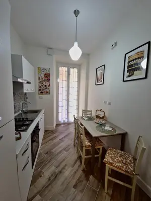 a kitchen and dining room with a table and chairs at Casa Milly in Rome