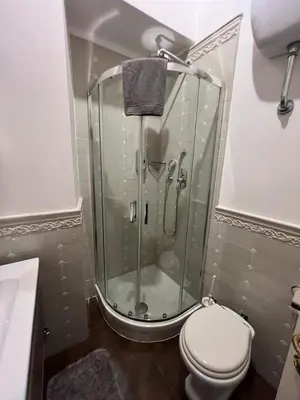 a bathroom with a shower and a toilet in it at S Angelo Apartment in Rome