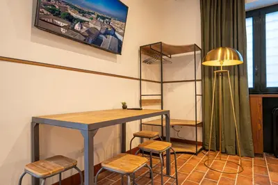 a room with a table and stools and a lamp at Trastevere 1 in Rome
