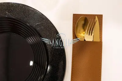 a fork and knife in a wooden holder next to a plate at BlueHouse Roma, ampia casa per gruppi e famiglie in Rome