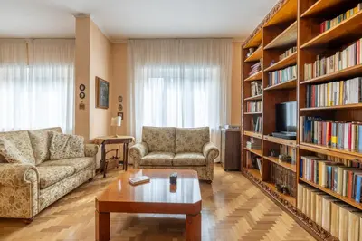 a living room with two couches and a book shelf at Roman Retreat Near the Appian Way & Catacombs in Rome