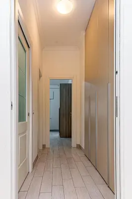 an empty hallway with a door and a tile floor at A Casa di Federico e Nikki - Vatican City - Metro Baldo degli Ubaldi in Rome