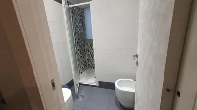 a bathroom with a sink and a toilet and a shower at Maison Tiburtina by Ghor in Rome