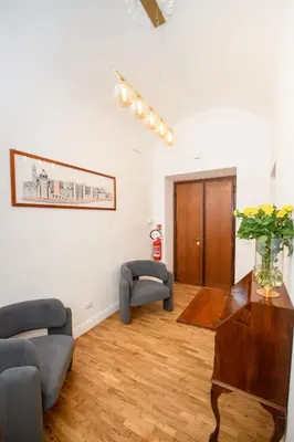 a living room with two chairs and a table at Boncompagni Serenity Suites in Rome