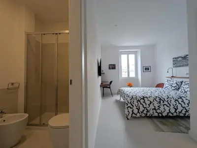 a bathroom with a bed and a shower and a toilet at Ostiense 353 Apartment by RS in Rome